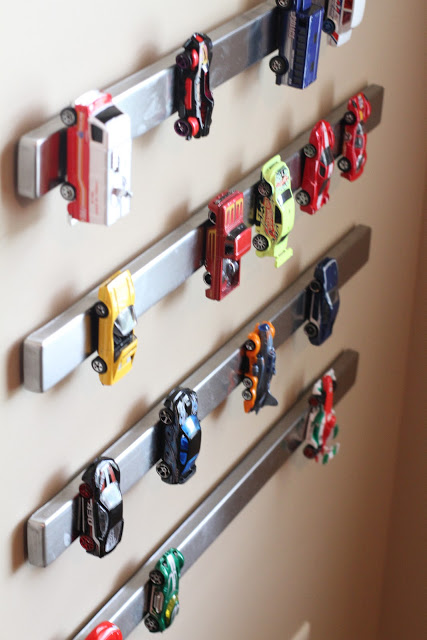 park toy cars on a magnetic knife rack