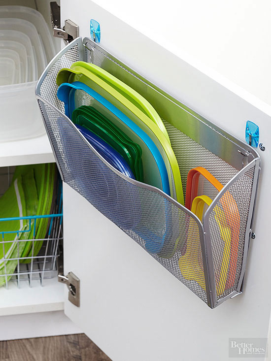 A wall file mounted to a cabinet door is an easy solution for separating plastic lids from bases