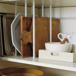 Storing baking sheets, cutting boards, and sturdy platters upright on kitchen shelves frees space and keeps you from having to lift a heavy stack.